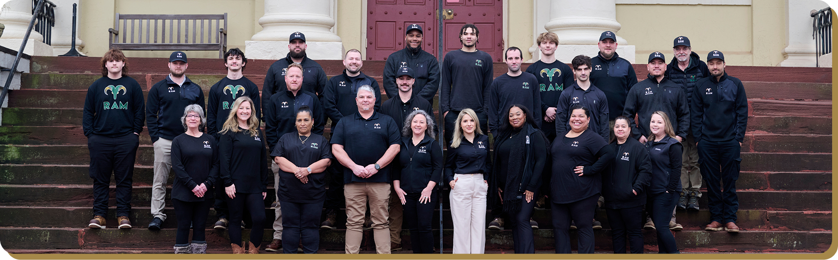 Team standing in front of RAM Restoration trucks