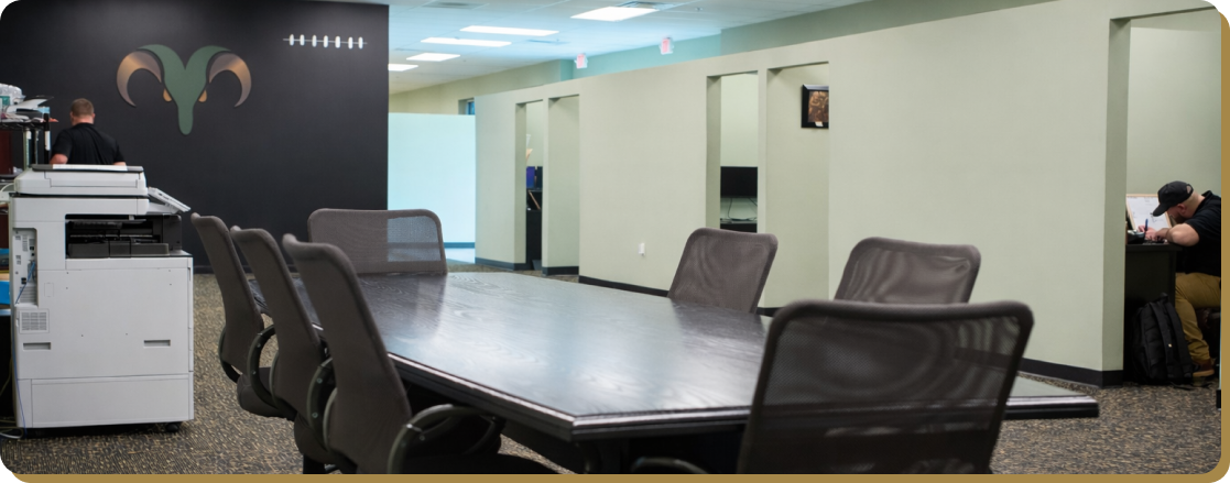 ram restoration office with large desk and employees at work